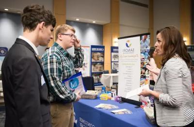 Students speaking with an employer at a career fair